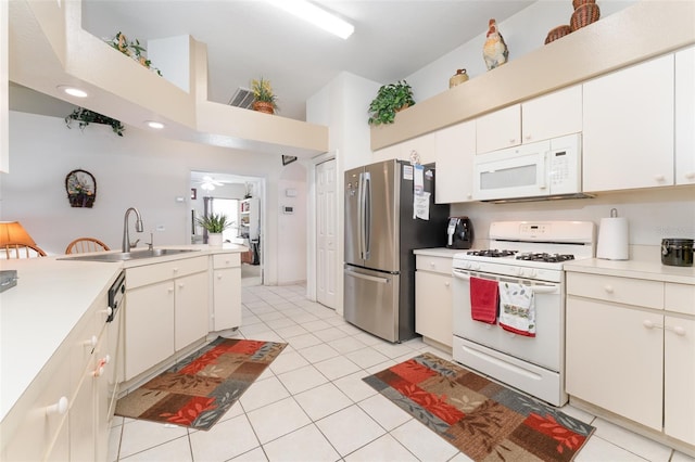 29542 Forest Glen Dr, Wesley Chapel, FL 33543 - kitchen featuring white appliances, light tile patterned floors, a sink, and light countertops