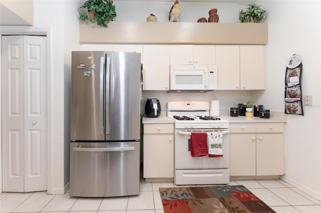 29542 Forest Glen Dr, Wesley Chapel, FL 33543 - kitchen with light tile patterned flooring, white appliances, light countertops, white cabinetry, and baseboards