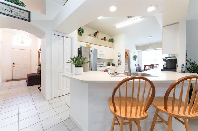 29542 Forest Glen Dr, Wesley Chapel, FL 33543 - kitchen featuring light countertops, white cabinetry, light tile patterned floors, and white appliances