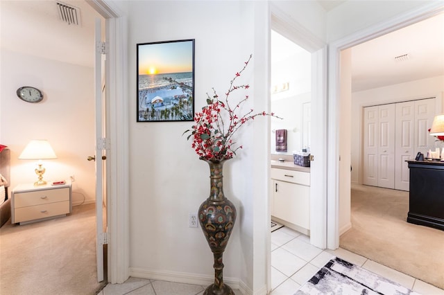 29542 Forest Glen Dr, Wesley Chapel, FL 33543 - hallway featuring light colored carpet, light tile patterned floors, and visible vents