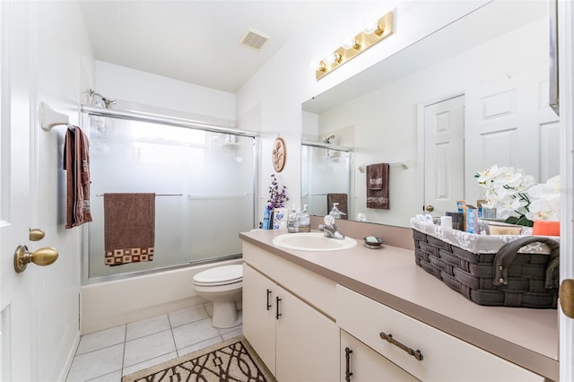 29542 Forest Glen Dr, Wesley Chapel, FL 33543 - bathroom with shower / bath combination with glass door, vanity, toilet, tile patterned floors, and visible vents