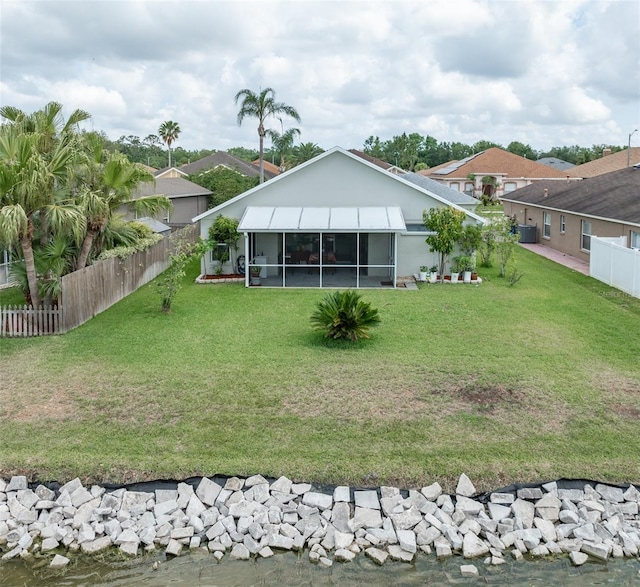 29542 Forest Glen Dr, Wesley Chapel, FL 33543 - rear view of property with a sunroom, a fenced backyard, and a yard