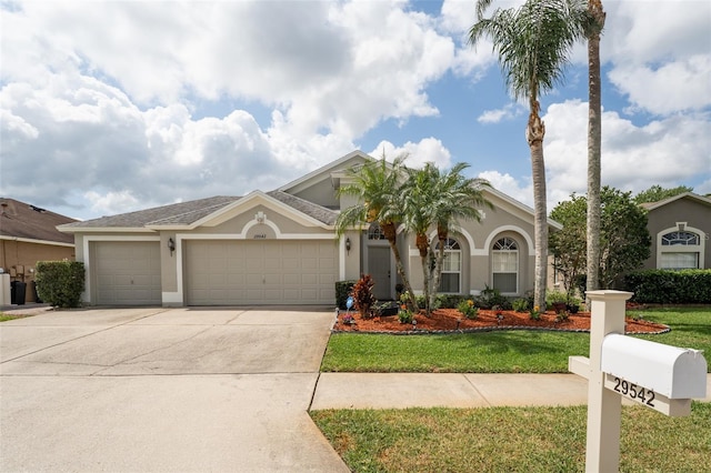 29542 Forest Glen Dr, Wesley Chapel, FL 33543 - mediterranean / spanish-style house with an attached garage, stucco siding, driveway, and a front yard