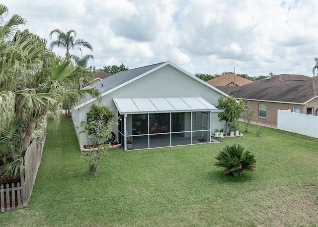29542 Forest Glen Dr, Wesley Chapel, FL 33543 - back of property with a lawn, fence, and a sunroom