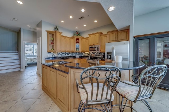 620 Bayway Blvd Unit 1, Clearwater, FL 33767 - kitchen featuring dark countertops, stainless steel appliances, recessed lighting, a large island, and tasteful backsplash
