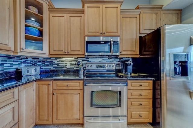 620 Bayway Blvd Unit 1, Clearwater, FL 33767 - kitchen featuring decorative backsplash, light brown cabinetry, glass insert cabinets, dark stone counters, and appliances with stainless steel finishes