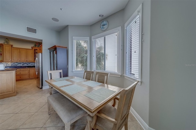 620 Bayway Blvd Unit 1, Clearwater, FL 33767 - dining area with visible vents, baseboards, plenty of natural light, and light tile patterned floors