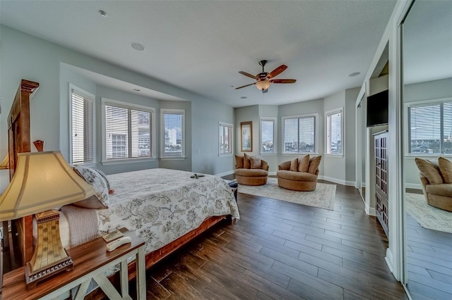 620 Bayway Blvd Unit 1, Clearwater, FL 33767 - bedroom with baseboards, dark wood finished floors, multiple windows, and ceiling fan