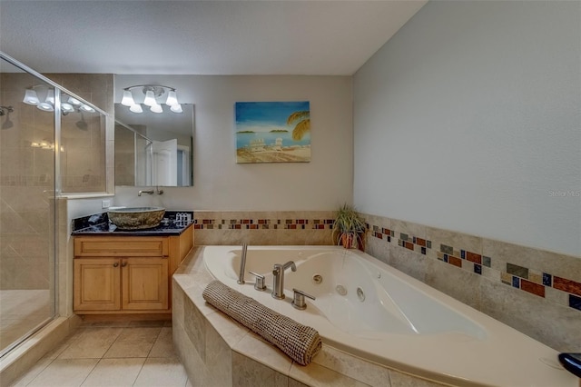 620 Bayway Blvd Unit 1, Clearwater, FL 33767 - bathroom featuring vanity, tile patterned floors, a whirlpool tub, and a stall shower