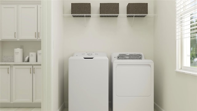 12058 Violet Jasper Dr, Parrish, FL 34219 - laundry room with baseboards, cabinet space, and washer and clothes dryer