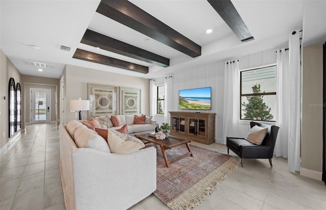 living area with visible vents, a wealth of natural light, and light tile patterned floors
