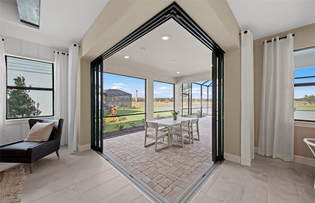 interior space featuring a healthy amount of sunlight, baseboards, recessed lighting, and light tile patterned flooring