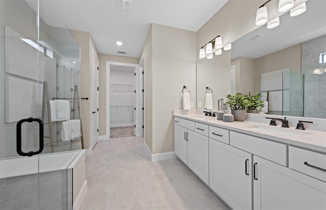 full bath with a sink, a stall shower, and recessed lighting