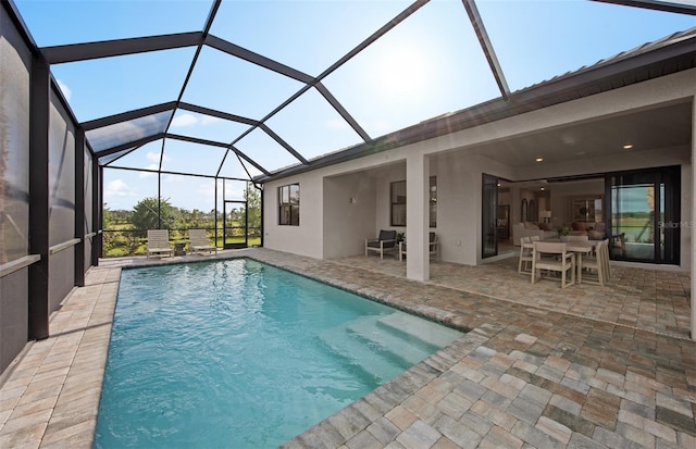 pool featuring a patio and glass enclosure
