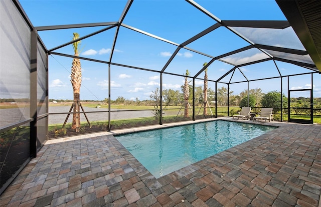 outdoor pool featuring glass enclosure and a patio area