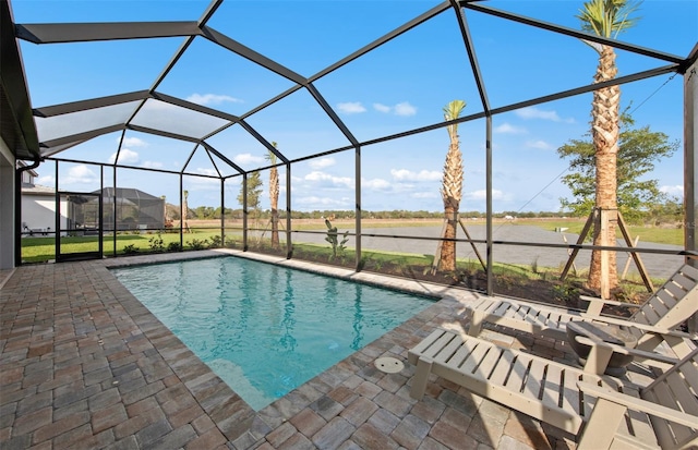 outdoor pool featuring a lanai and a patio