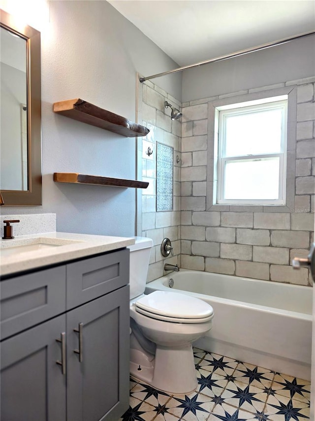 bathroom with toilet, vanity, and shower / washtub combination
