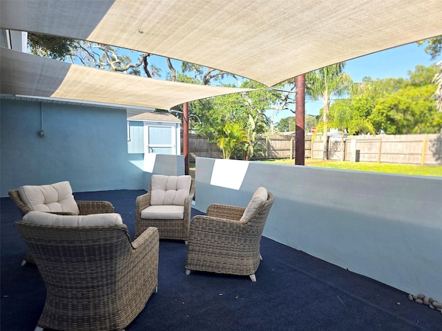 view of patio / terrace featuring an outdoor structure, a shed, and a fenced backyard