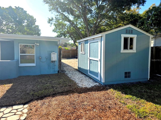 view of shed with fence