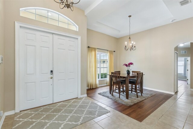 20254 Ravens End Dr, Tampa, FL 33647 - foyer entrance with an inviting chandelier, arched walkways, tile patterned floors, and visible vents