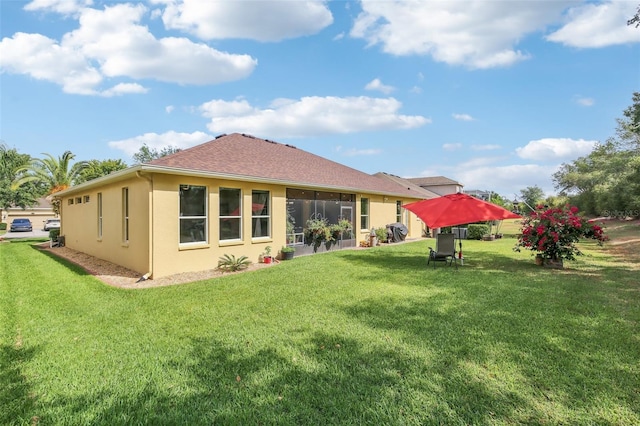 20254 Ravens End Dr, Tampa, FL 33647 - back of property featuring a lawn, a shingled roof, and stucco siding
