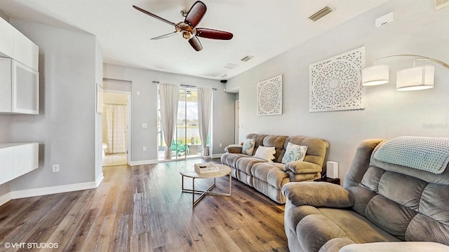 living room featuring baseboards, ceiling fan, wood finished floors, and visible vents