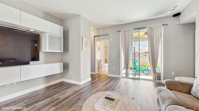 living room with baseboards and wood finished floors