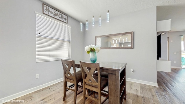 dining room with baseboards and light wood-style floors