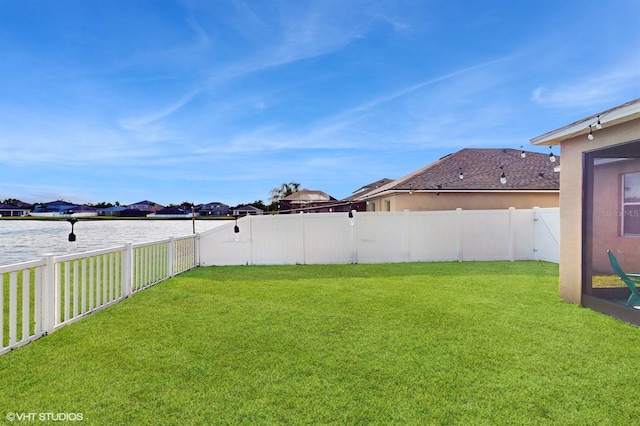 view of yard featuring a residential view and a fenced backyard