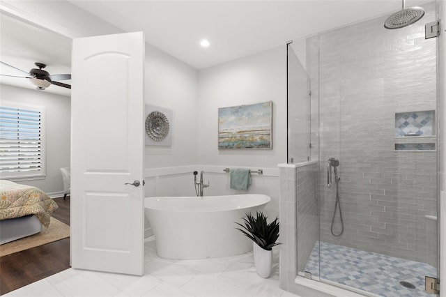 full bathroom with a shower stall, recessed lighting, a soaking tub, a ceiling fan, and ensuite bath