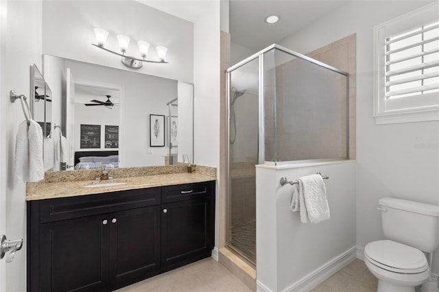 bathroom with a stall shower, vanity, tile patterned floors, toilet, and ensuite bathroom