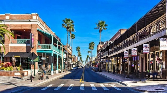 view of road featuring sidewalks, curbs, and street lights