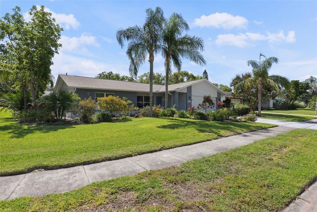 ranch-style home featuring a front yard and a garage