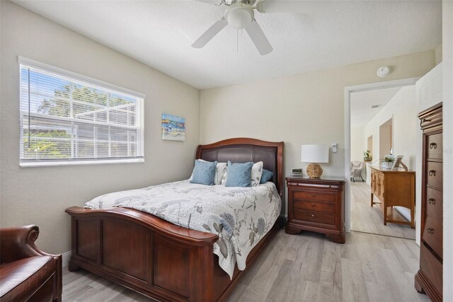 bedroom featuring light wood-style floors and ceiling fan
