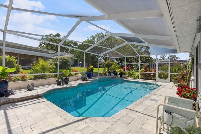pool featuring a patio and glass enclosure