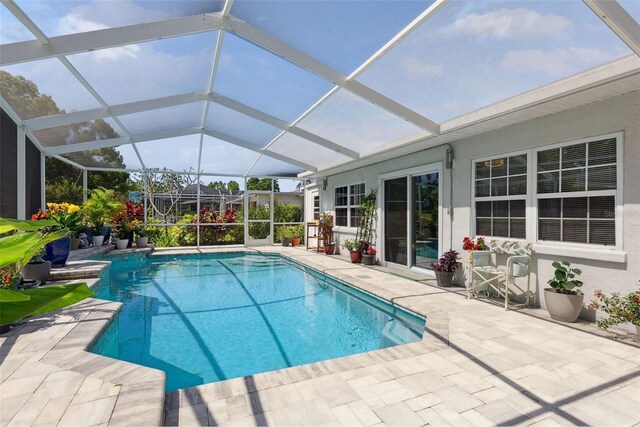outdoor pool with a patio area and a lanai