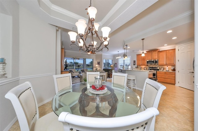 dining room with an inviting chandelier, a raised ceiling, crown molding, and recessed lighting