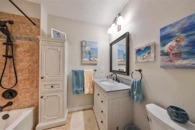 bathroom with vanity, tub / shower combination, toilet, baseboards, and tile patterned floors