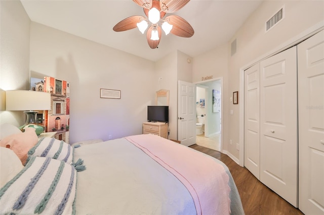 bedroom with ceiling fan, visible vents, wood finished floors, and a closet