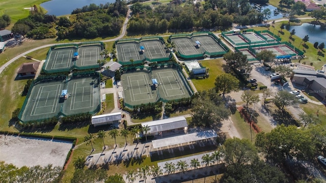 bird's eye view with a water view and view of golf course