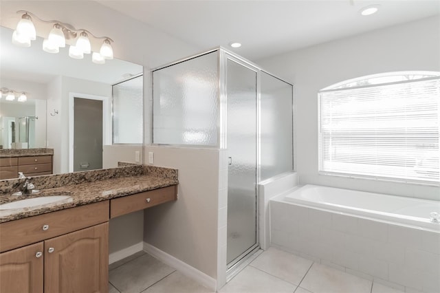 2203 Malaga Ave, Spring Hill, FL 34609 - bathroom with tile patterned flooring, a shower stall, a garden tub, and vanity