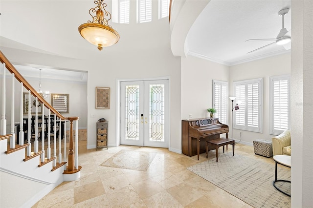 entryway with french doors, ornamental molding, stairs, and baseboards