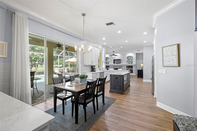 dining space with ceiling fan, light wood finished floors, recessed lighting, baseboards, and ornamental molding
