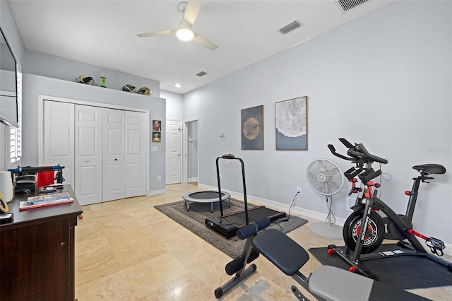 exercise room with baseboards, a ceiling fan, and visible vents