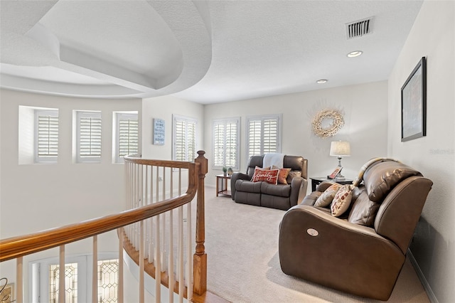 sitting room featuring recessed lighting, an upstairs landing, light carpet, and visible vents