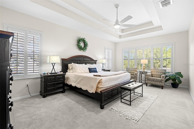 bedroom with visible vents, baseboards, and multiple windows