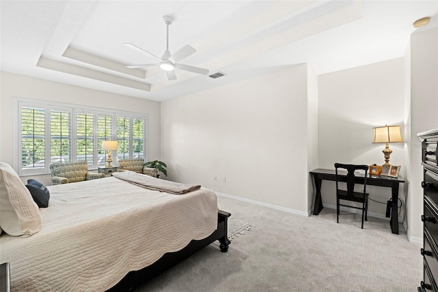 bedroom with baseboards, a ceiling fan, light colored carpet, and visible vents