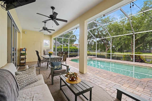 outdoor pool with a grill, an outdoor hangout area, a ceiling fan, a patio area, and a lanai