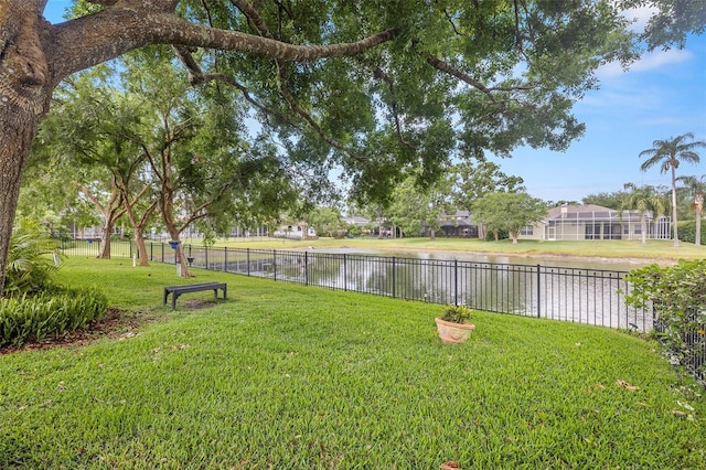 view of yard featuring fence and a water view