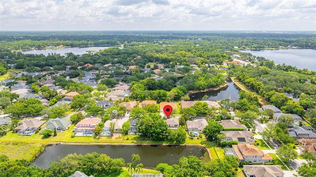 birds eye view of property with a water view and a residential view